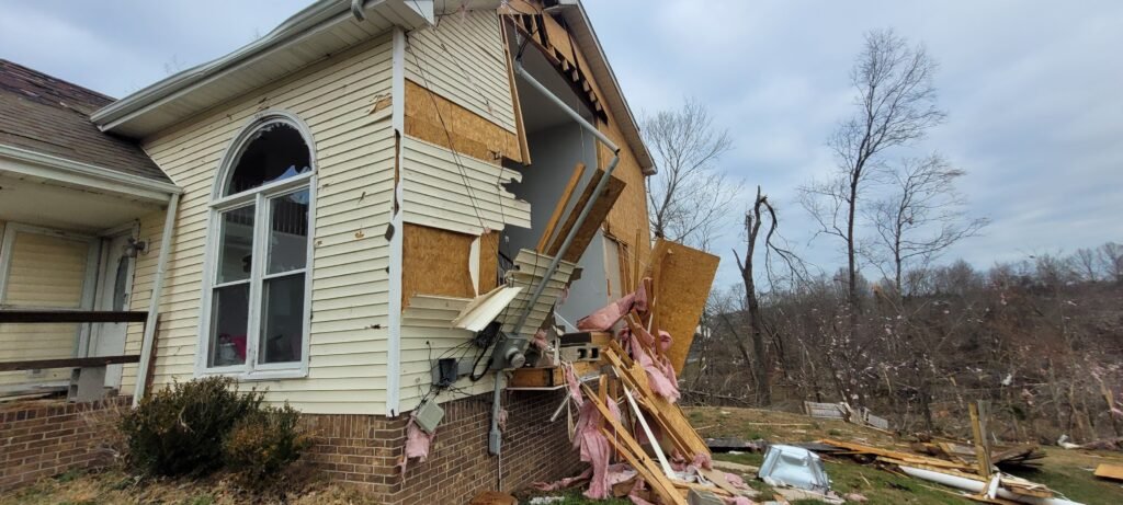 tornado damage repair with exterior siding removal and structural damage to home