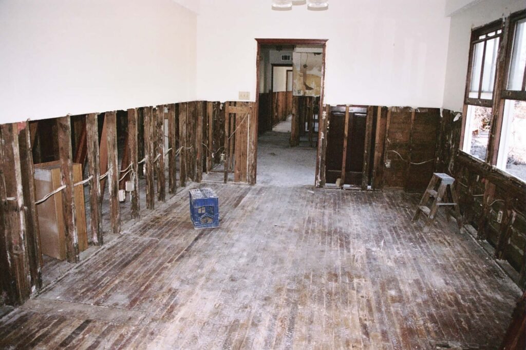 Water damage restoration project with exposed wall studs and interior structural repair